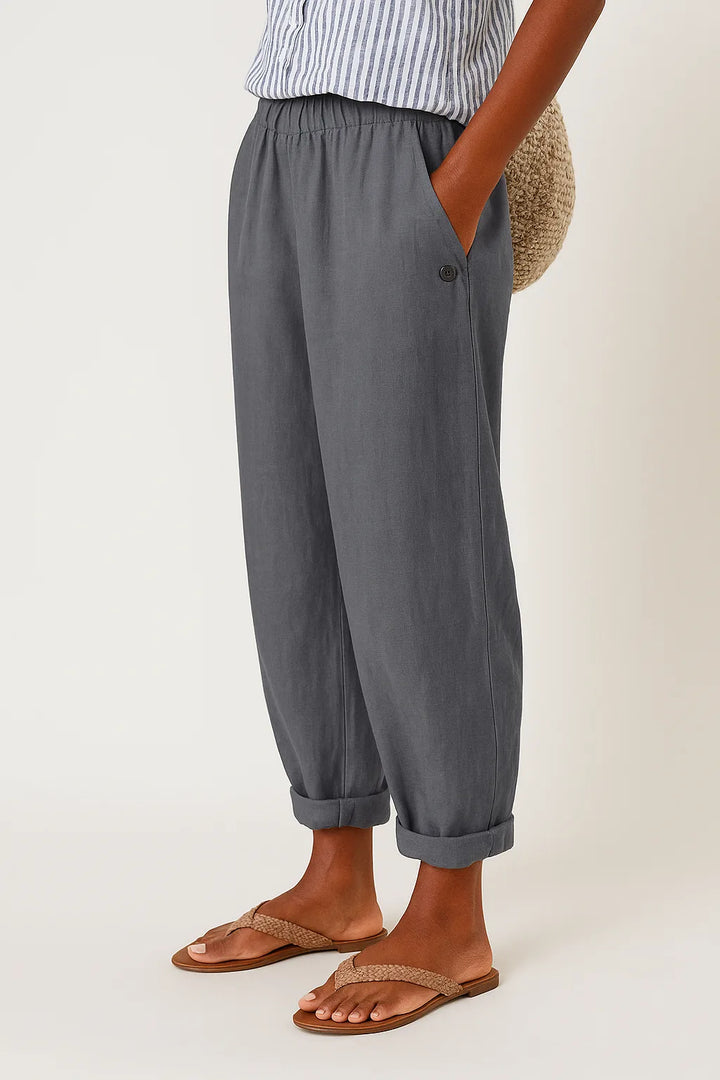 Gray tapered rolled cuff pants, full-length model view