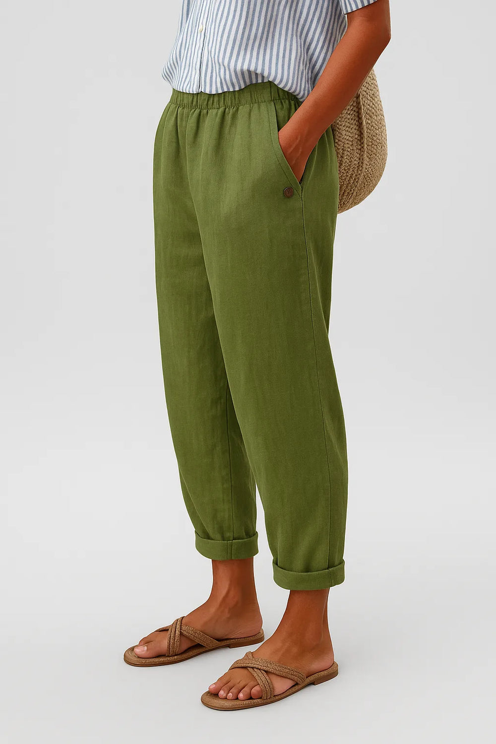 Green tapered rolled cuff pants, model in three-quarter turn pose