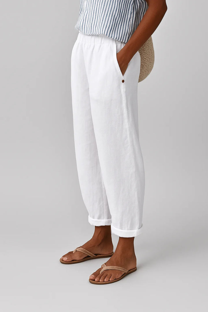 White tapered rolled cuff pants, full-length model view