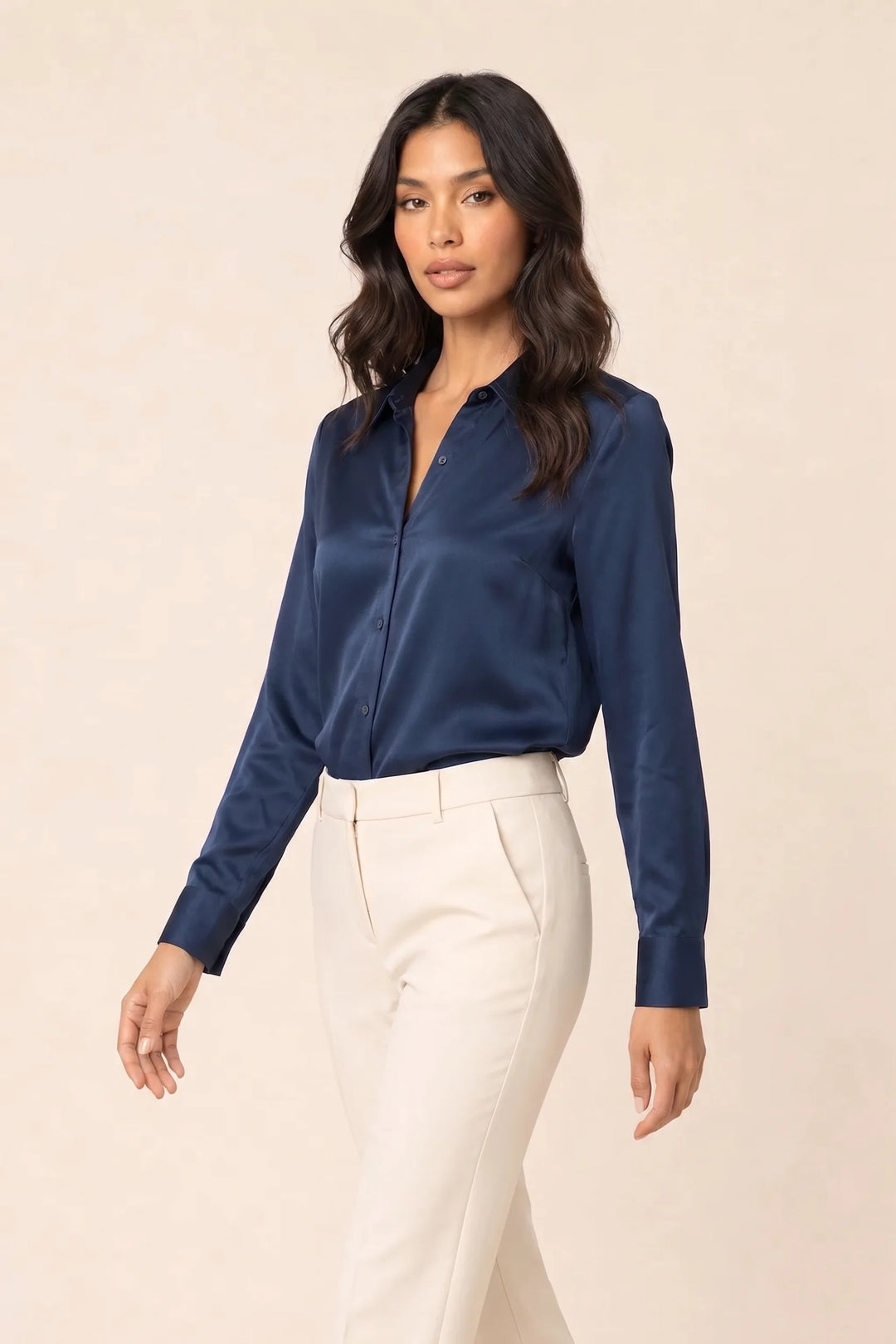 Navy blue satin button-front blouse on model in three-quarter turn