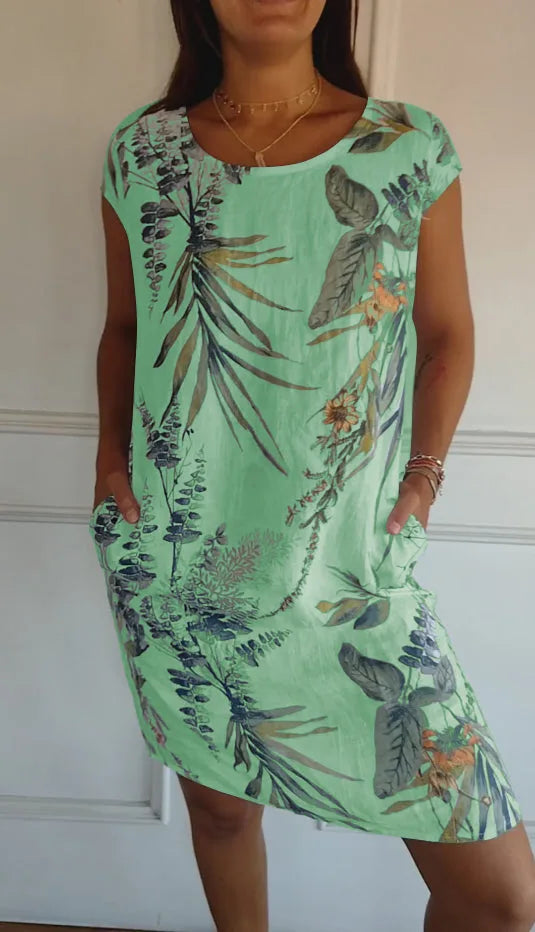 Green botanical print midi dress on standing model