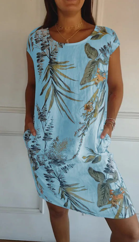 Light blue botanical print midi dress on standing model