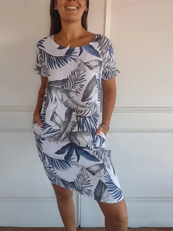 Off-white botanical print midi dress on model in three-quarter turn