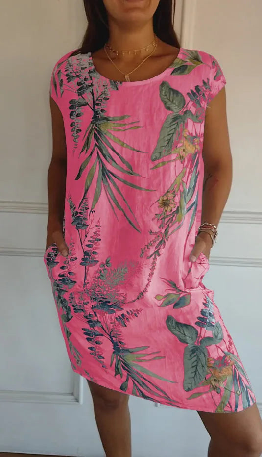 Pink botanical print midi dress on standing model
