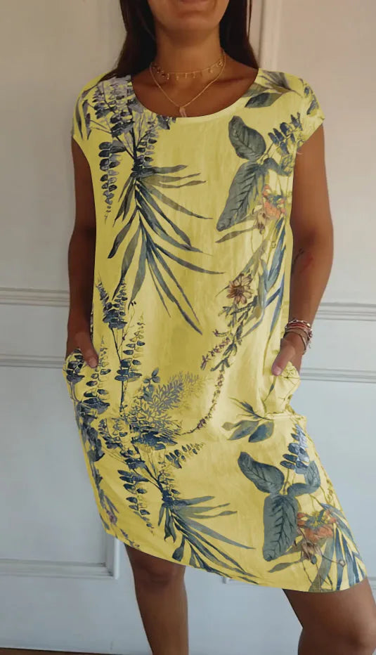 Yellow botanical print midi dress on standing model