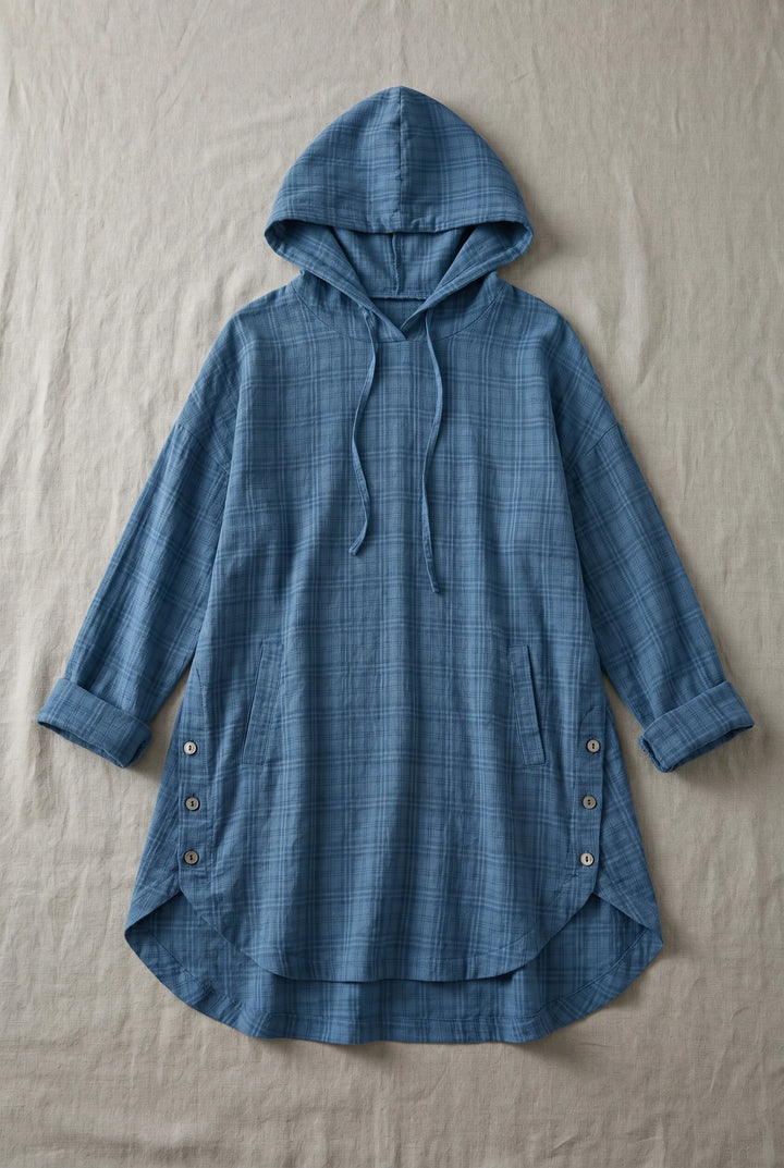 Blue hooded tunic dress laid flat, showing full-length silhouette with drawstring hood and relaxed fit