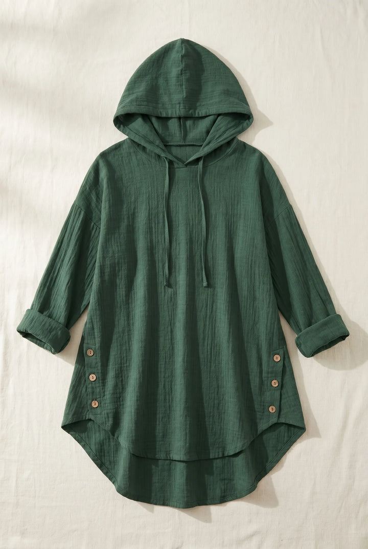 Green hooded tunic dress laid flat, showing full-length silhouette with drawstring hood and relaxed fit