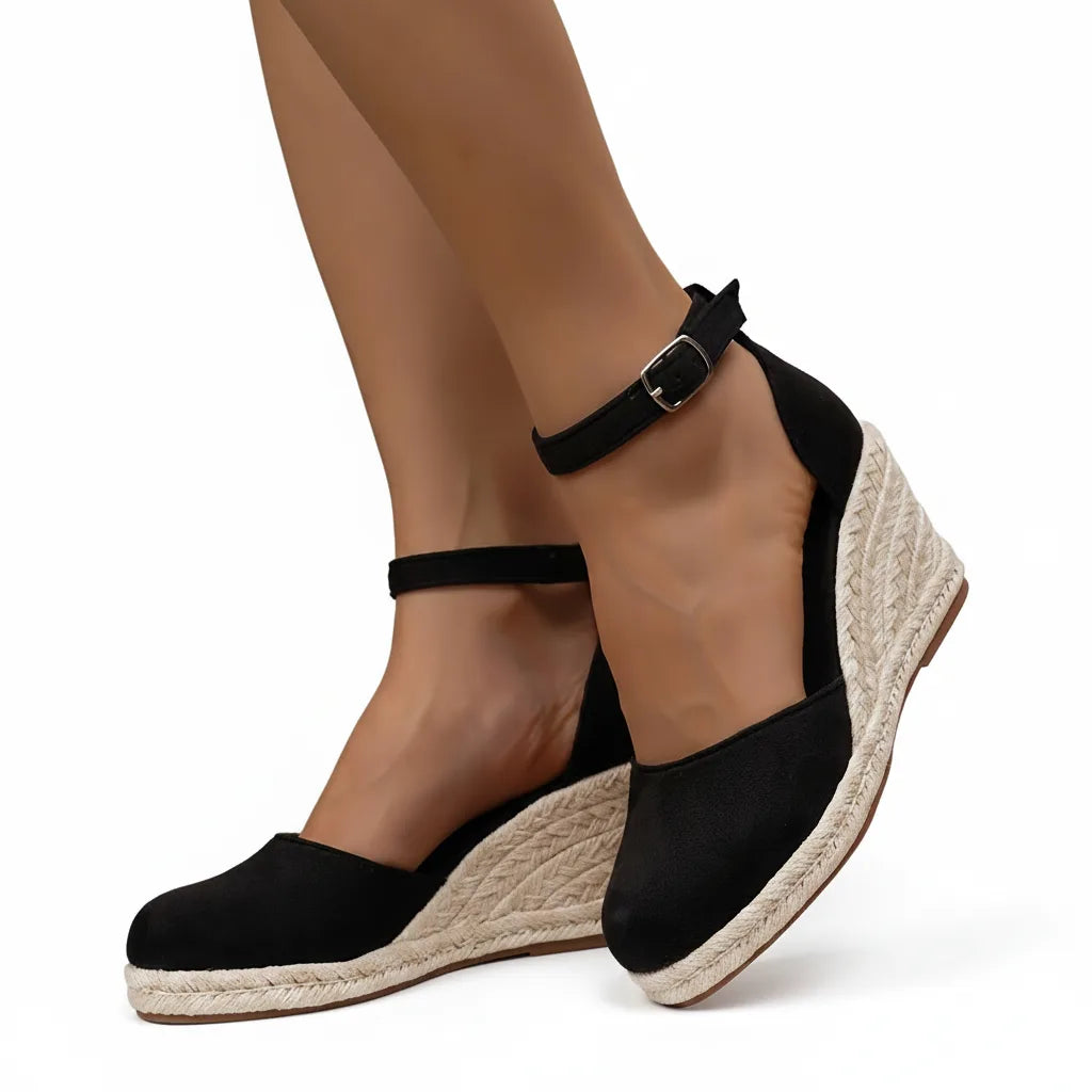 Black espadrille wedge sandal, front view showing toe straps and jute platform