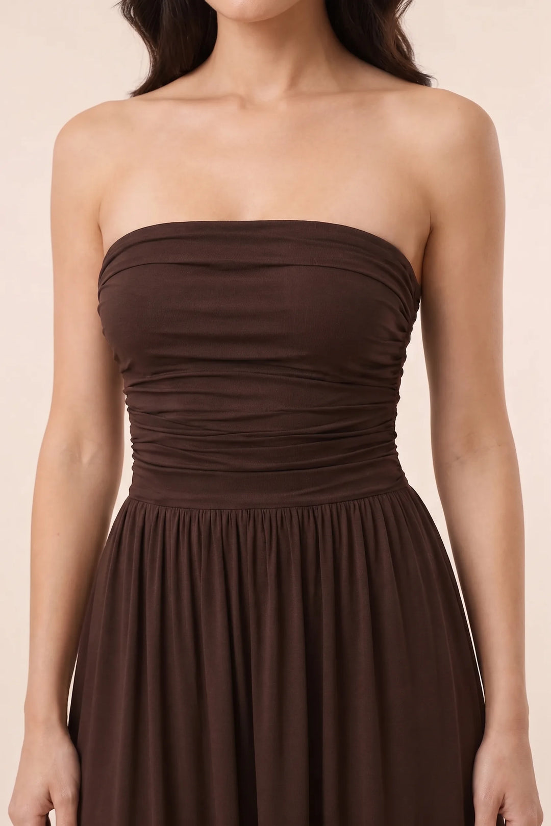 Close-up detail of brown strapless ruched maxi dress fabric and silhouette