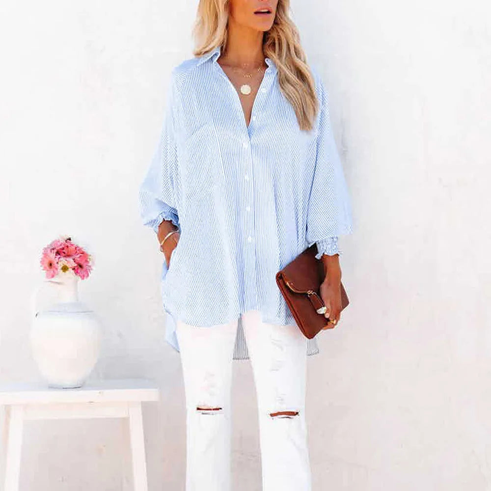 Close-up detail of smocked cuff on a blue balloon sleeve blouse