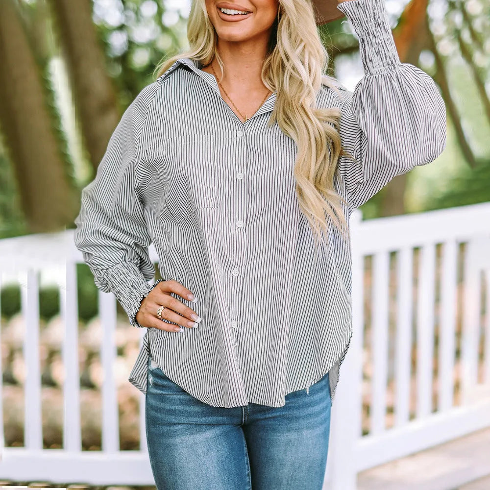 Model wearing a blue balloon sleeve blouse with smocked cuffs, alternate view