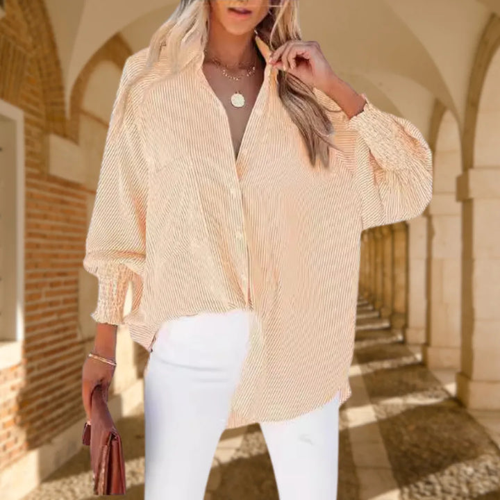 Model wearing a yellow balloon sleeve blouse with smocked cuffs