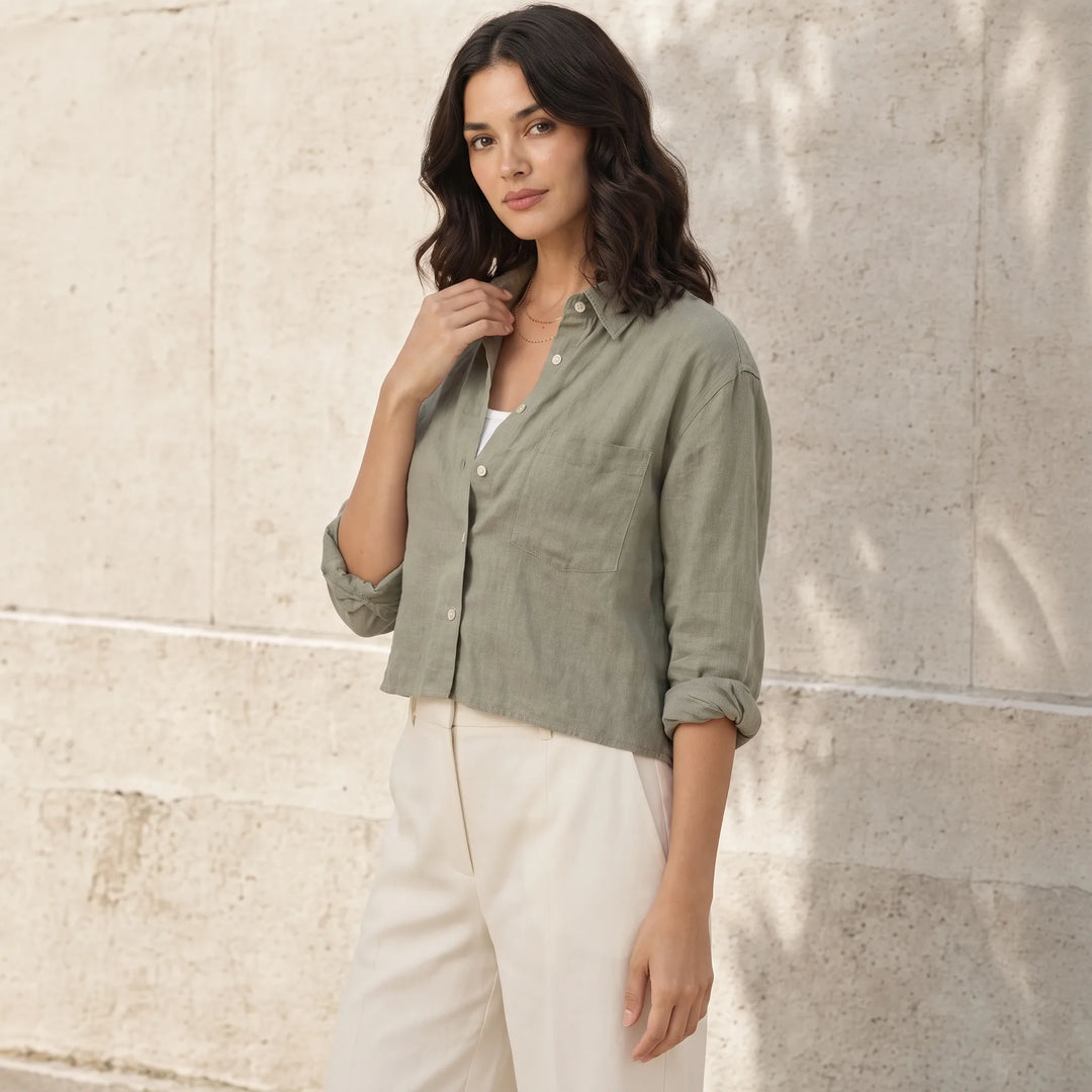 Cropped dark green button-down shirt on model in three-quarter turn