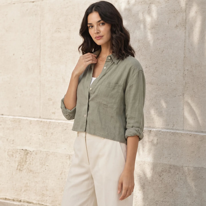 Cropped dark green button-down shirt on model in three-quarter turn