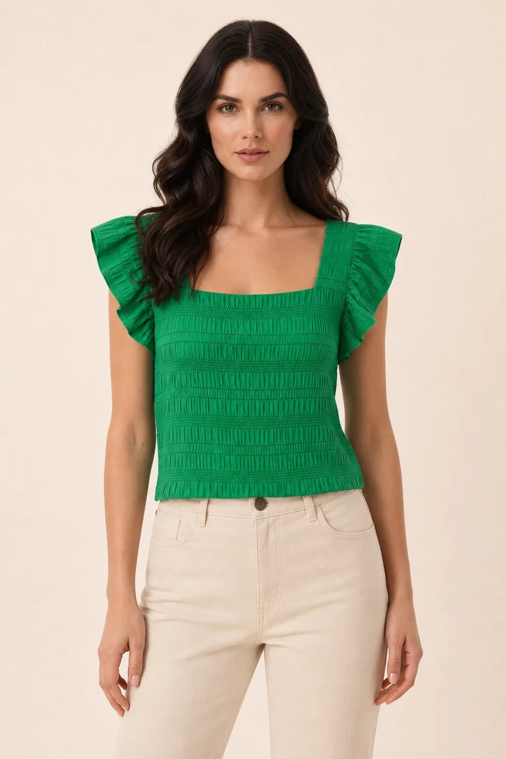 Green smocked ruffle sleeve top on model in contrapposto stance