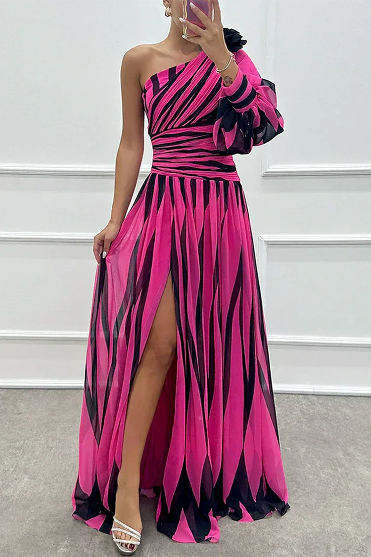 Close-up detail of a rose red one-shoulder gown showing fabric texture and shoulder strap