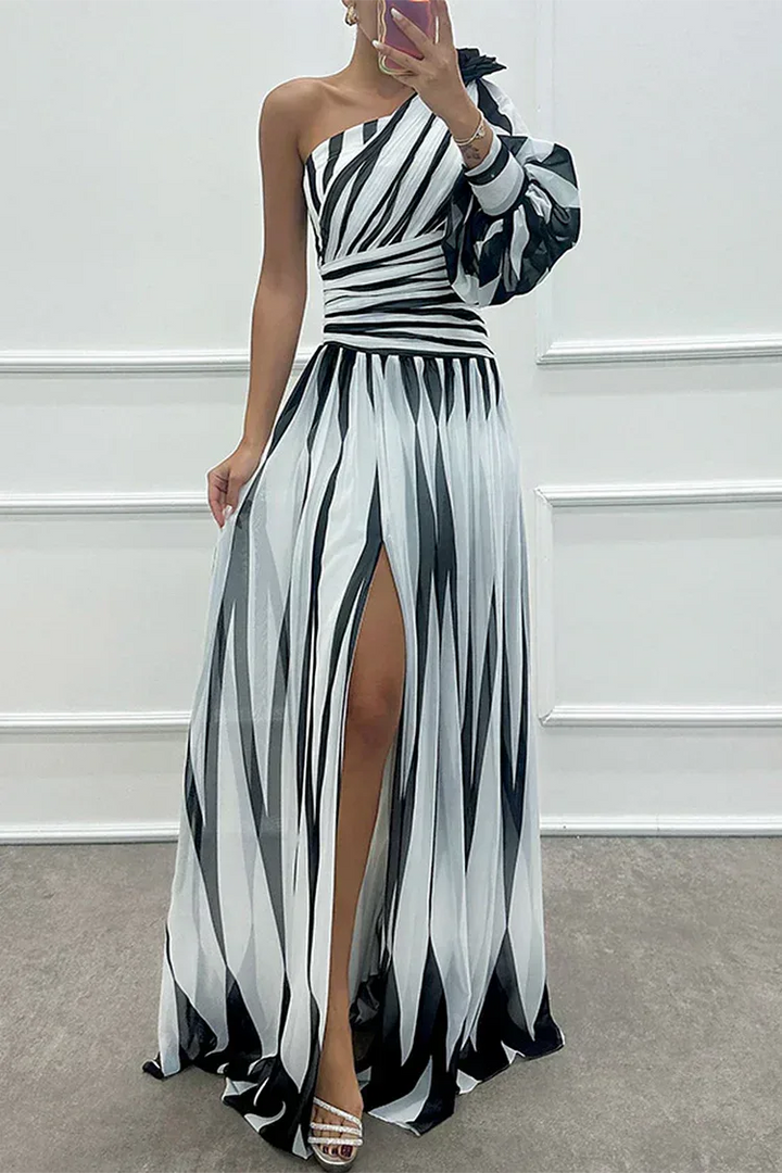Woman in a white one-shoulder floor-length gown with a front leg slit, facing forward