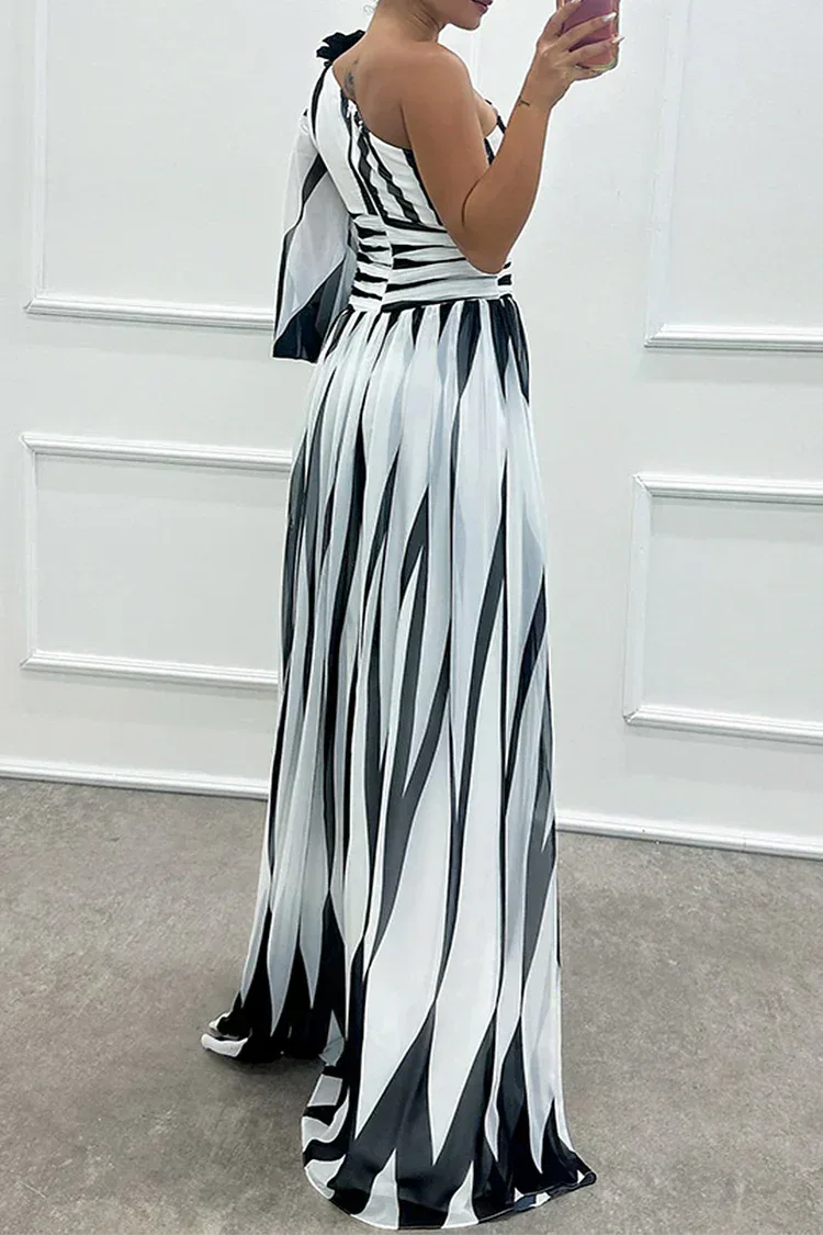 Woman in a white one-shoulder slit gown, side profile highlighting the draped fabric