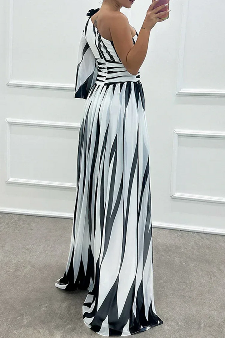 Woman in a white one-shoulder slit gown, side profile highlighting the draped fabric