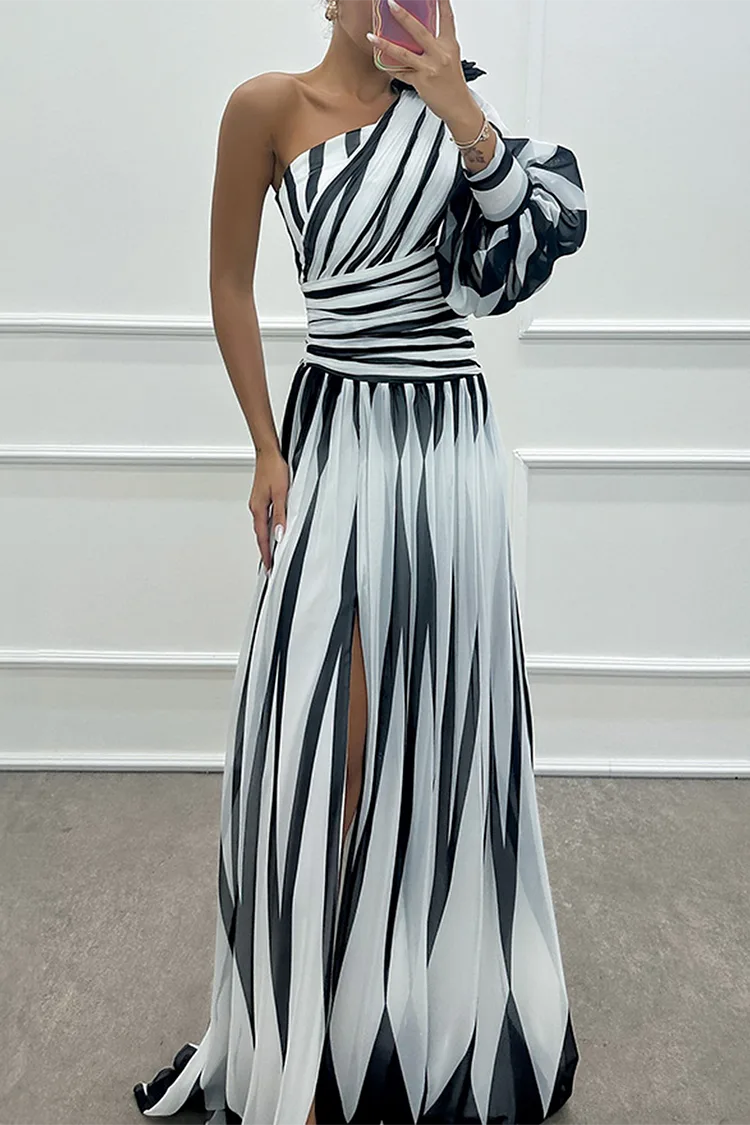 Woman in a white one-shoulder slit gown, turned three-quarters to show silhouette