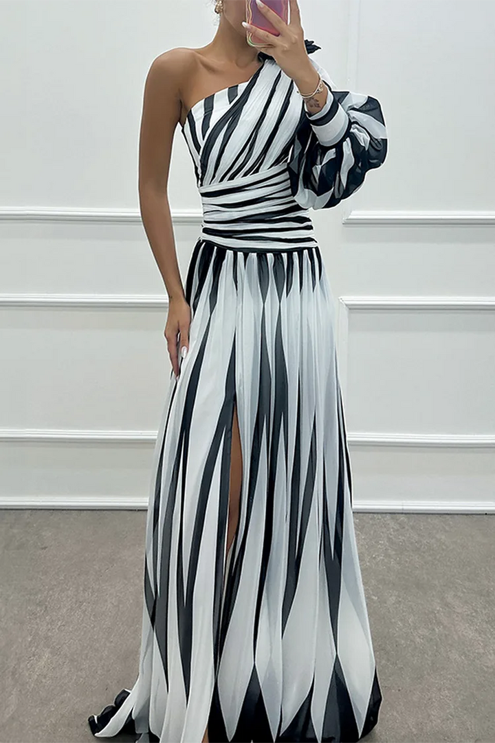Woman in a white one-shoulder slit gown, turned three-quarters to show silhouette