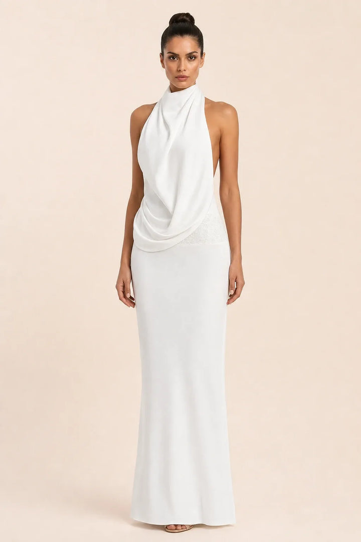 White draped open-back gown on model in contrapposto stance