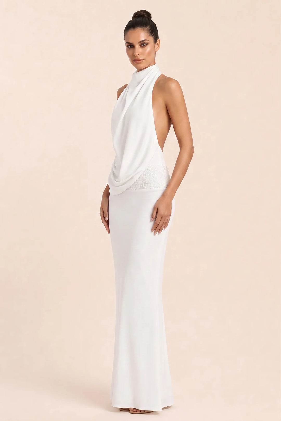 White draped open-back gown on model in three-quarter turn