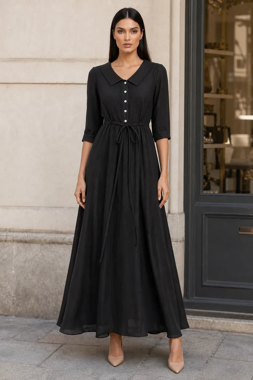 Black tie waist midi dress on model in contrapposto stance