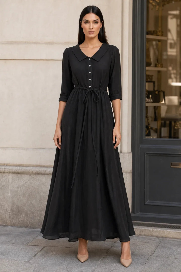 Black tie waist midi dress on model in contrapposto stance