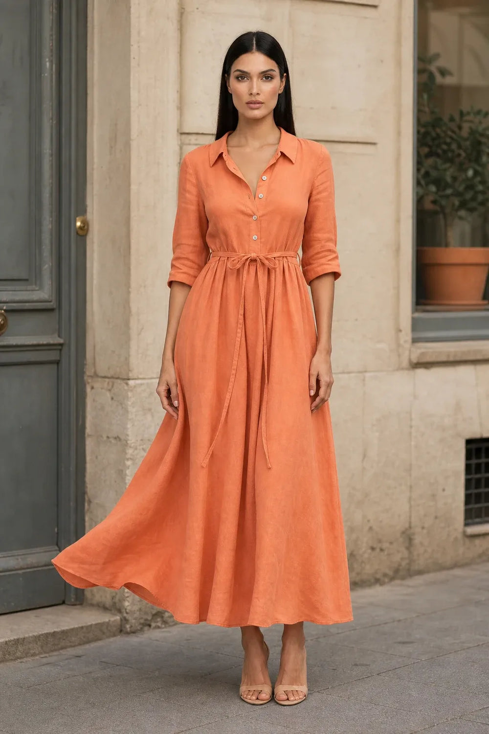 Orange tie waist midi dress on model in contrapposto stance