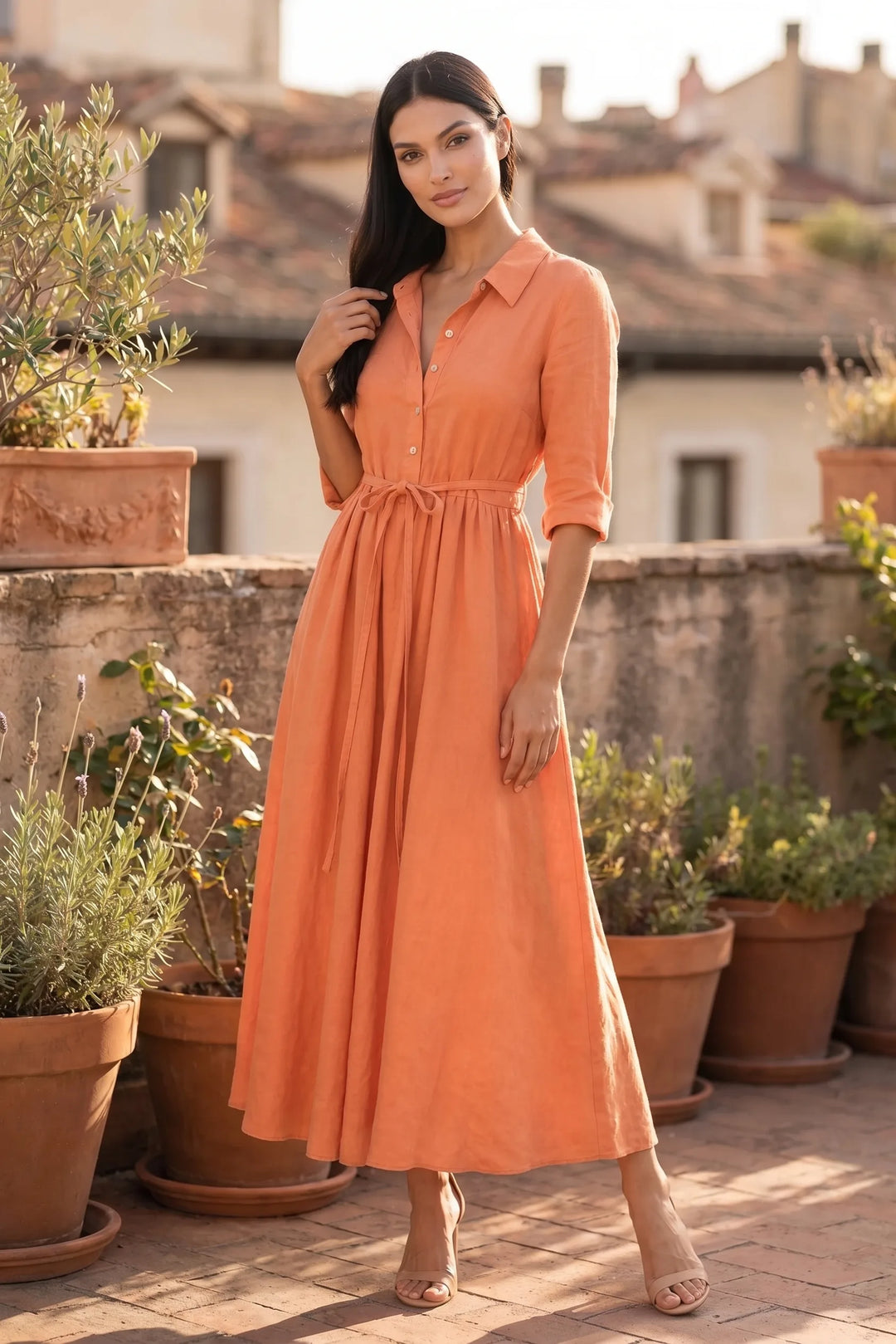 Model wearing orange tie waist midi dress in outdoor lifestyle setting