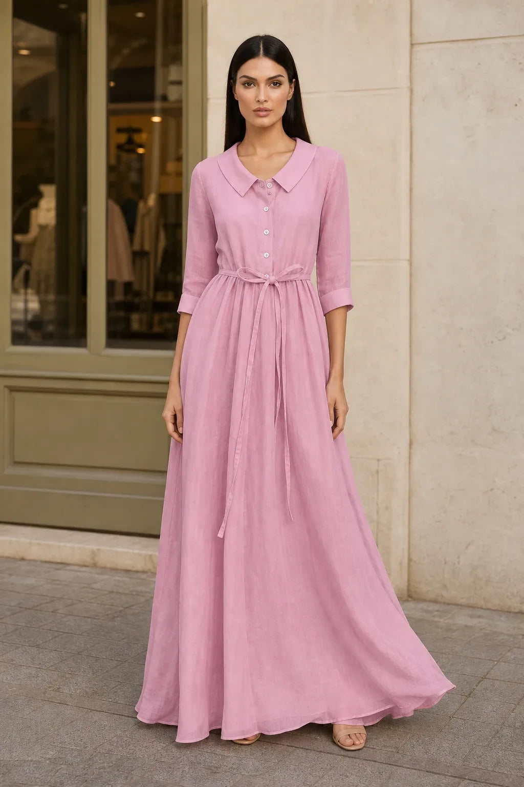 Pink tie waist midi dress on model in contrapposto stance