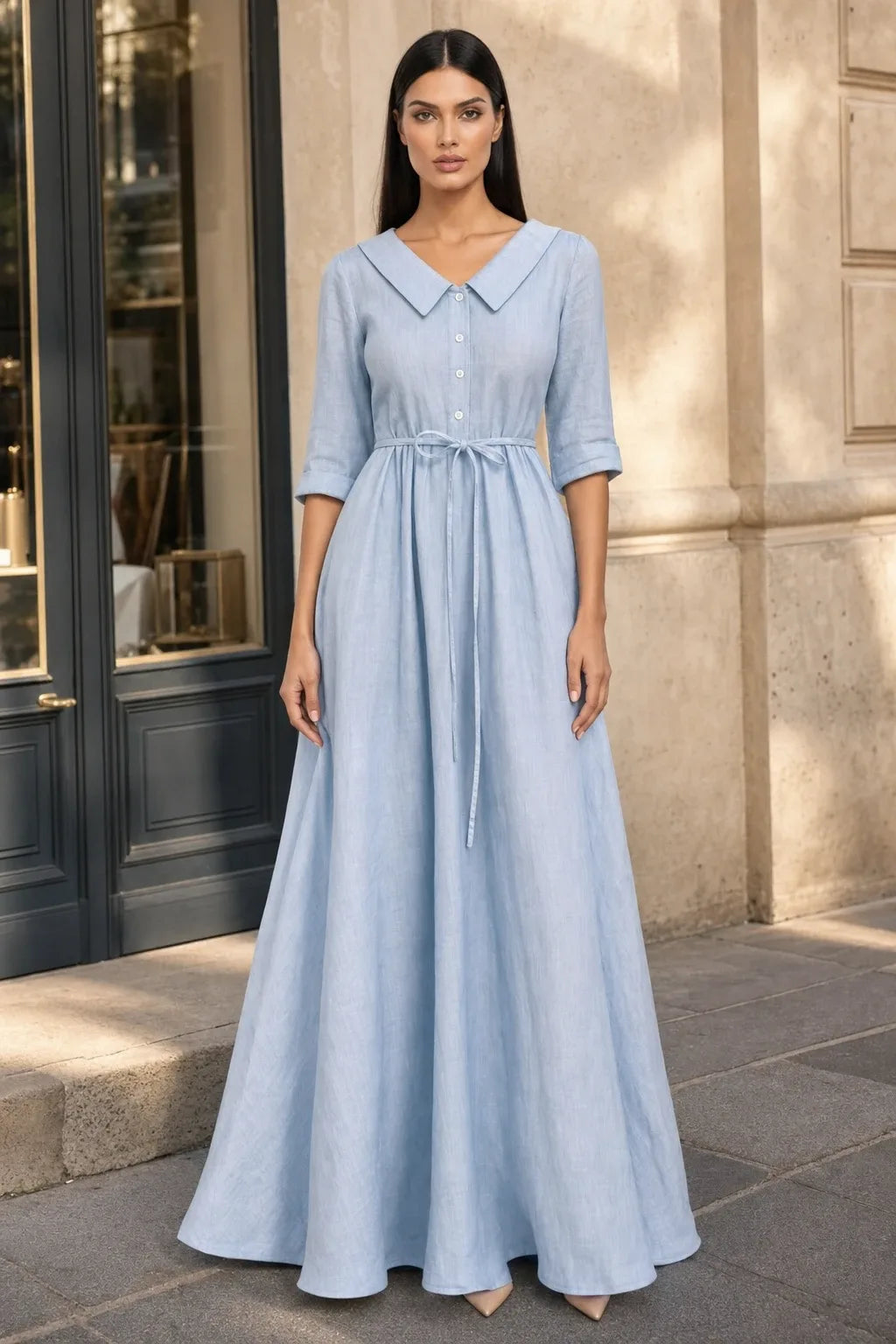 Sky blue tie waist midi dress on model in contrapposto stance