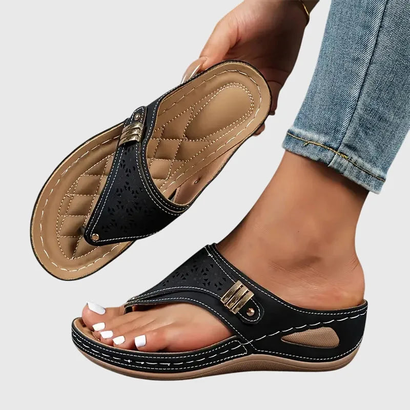 Black wedge thong sandal, front view showing toe strap and platform sole