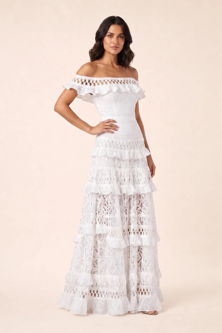 White tiered lace gown on model in three-quarter turn, showing back and skirt volume