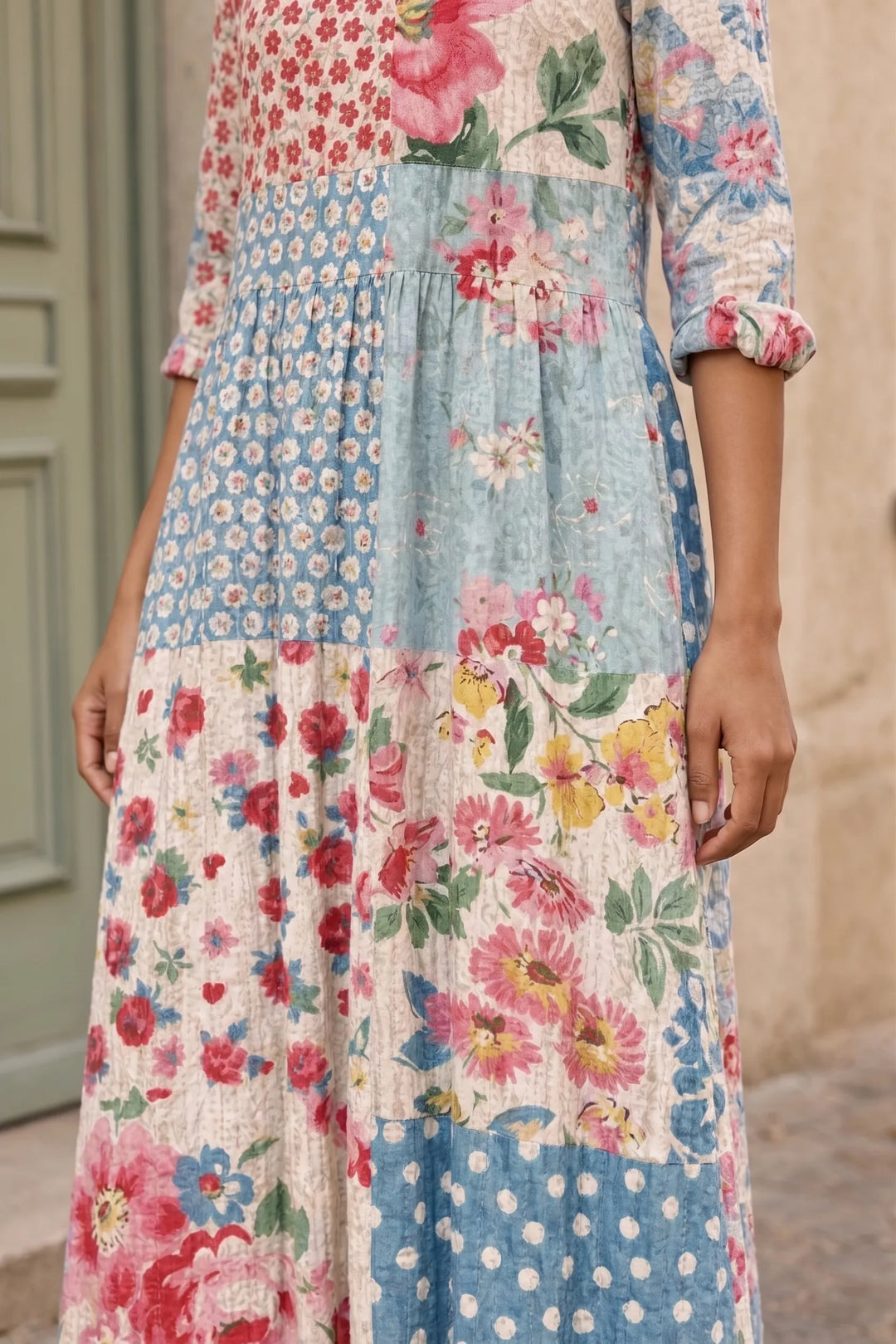 Close-up detail of light blue patchwork floral maxi dress fabric and pattern