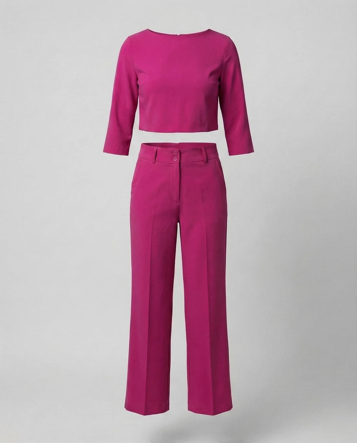 Woman wearing a dark pink wide-leg trouser co-ord set with matching blazer