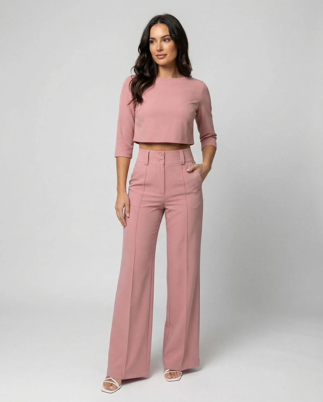 Woman facing forward in a pink wide-leg trouser co-ord set with matching blazer