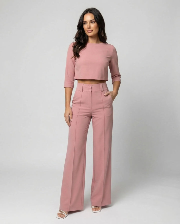 Woman facing forward in a pink wide-leg trouser co-ord set with matching blazer