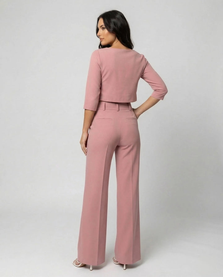 Side view of a woman wearing a pink wide-leg trouser and blazer co-ord set