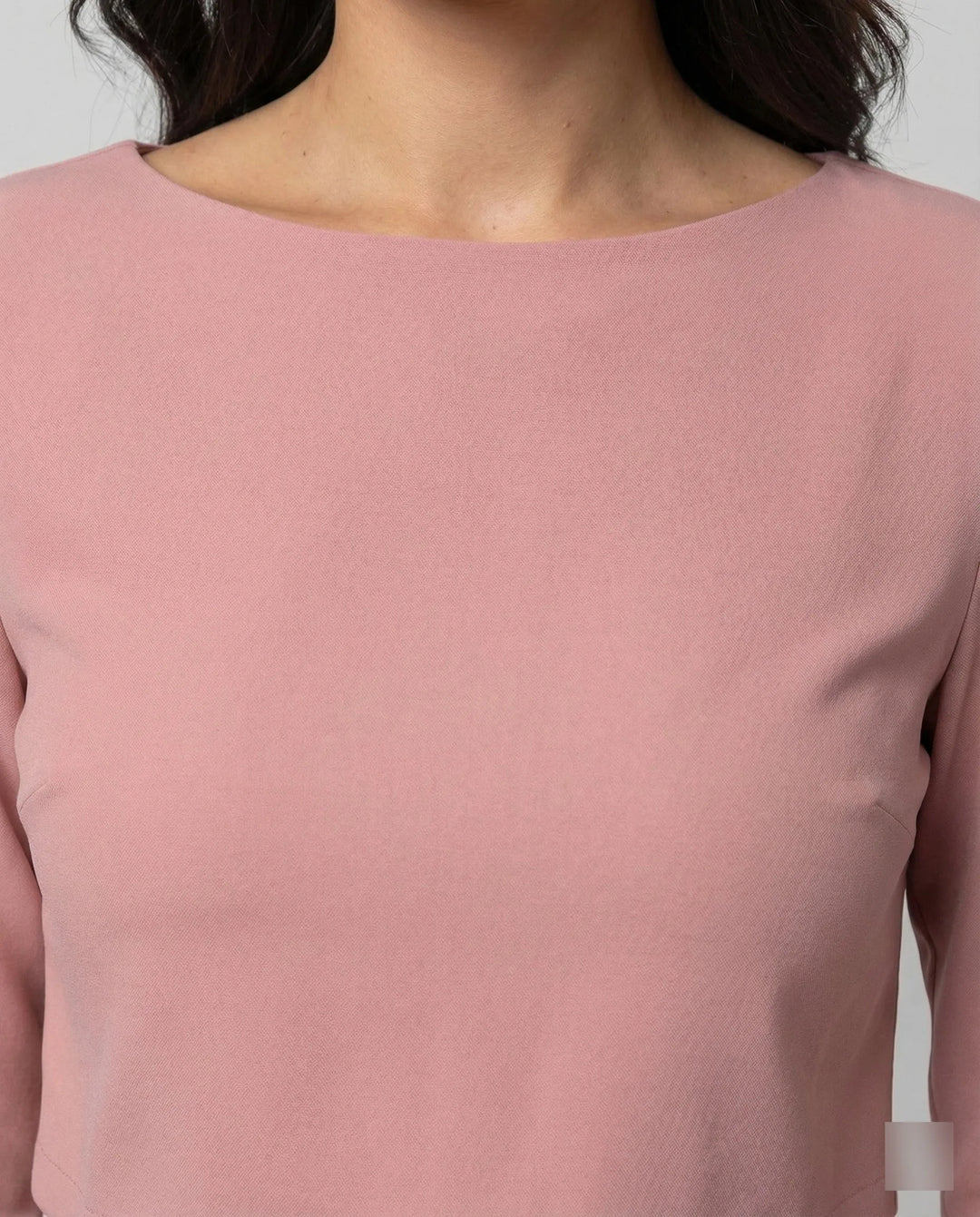 Woman in a pink wide-leg trouser set turned three-quarters to show silhouette