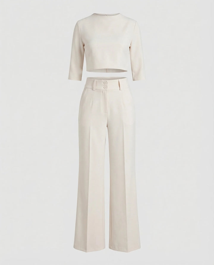 Woman wearing a white wide-leg trouser co-ord set with matching blazer