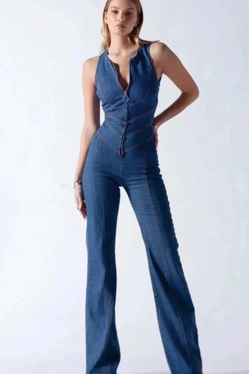 Model in side profile wearing a sleeveless deep V flared jumpsuit