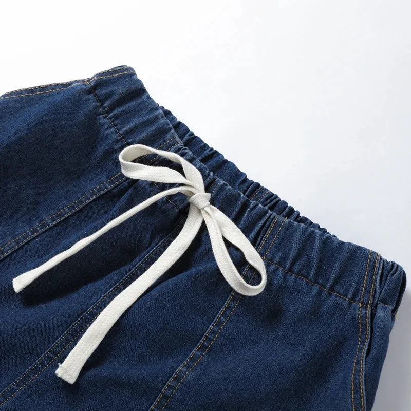 Model wearing a blue denim shirt co-ord set, rear or side angle