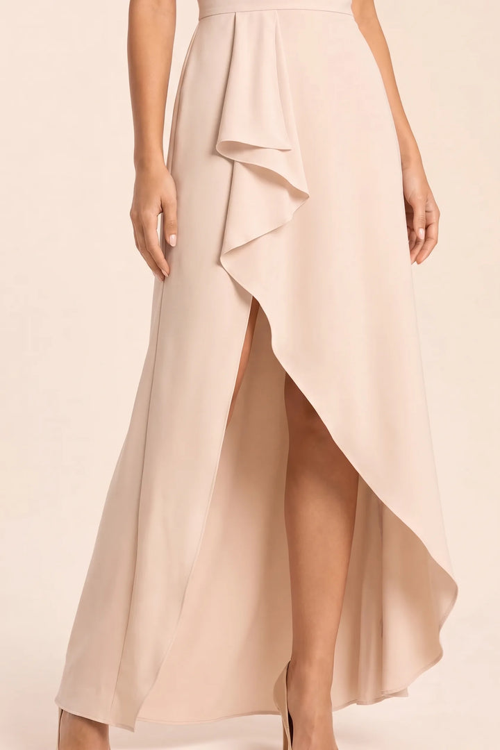Close-up detail of apricot ruffle asymmetric midi skirt hem and tiers