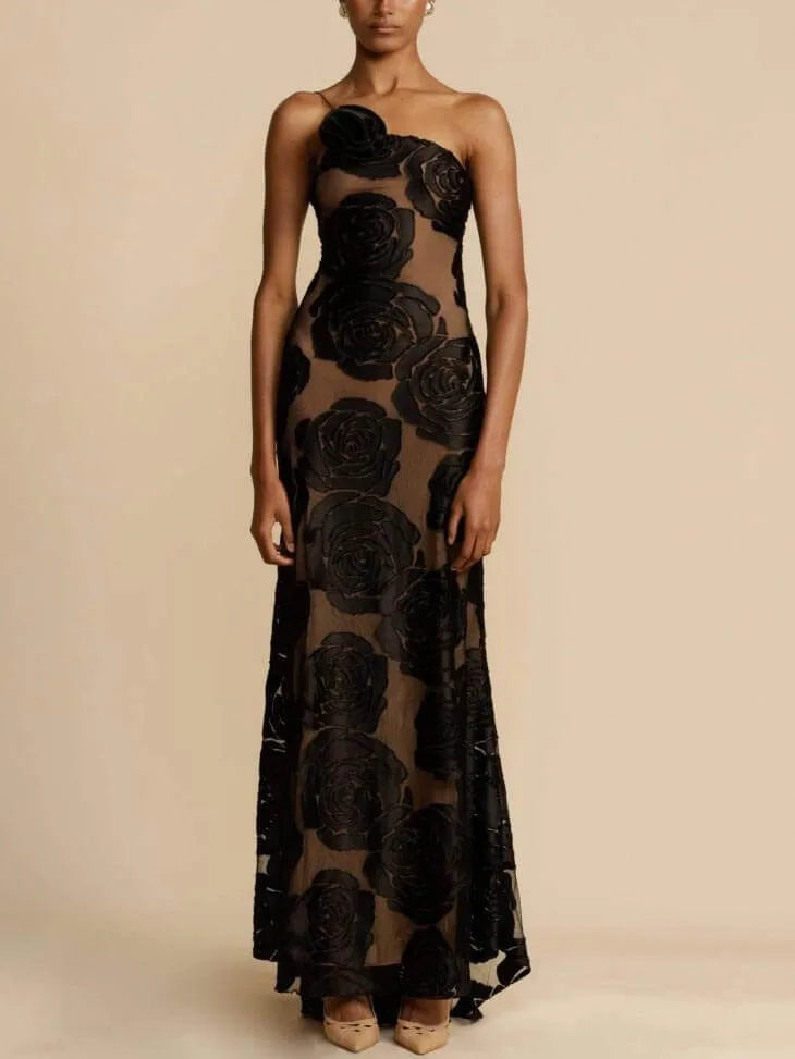 Close-up of 3D rose appliqués on black gown fabric