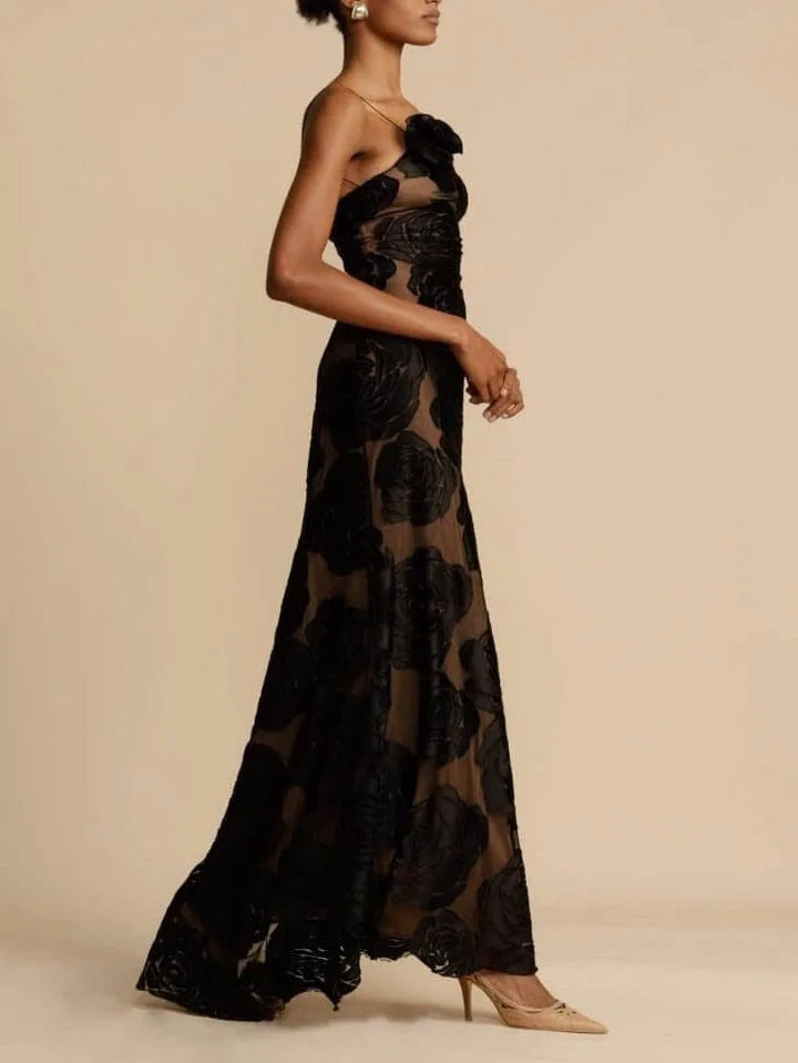 Side view of model in a black floor-length gown with 3D rose appliqué detailing