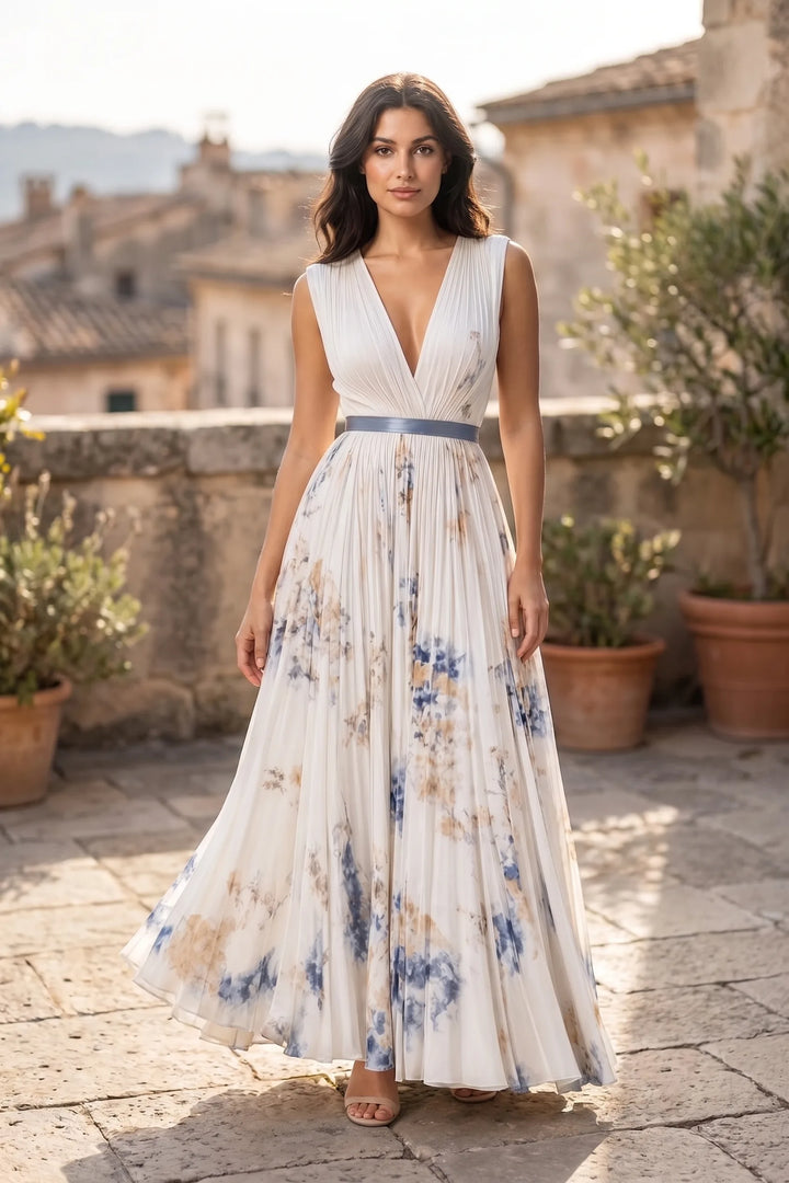 Model wearing a beige pleated floral midi dress in a lifestyle setting