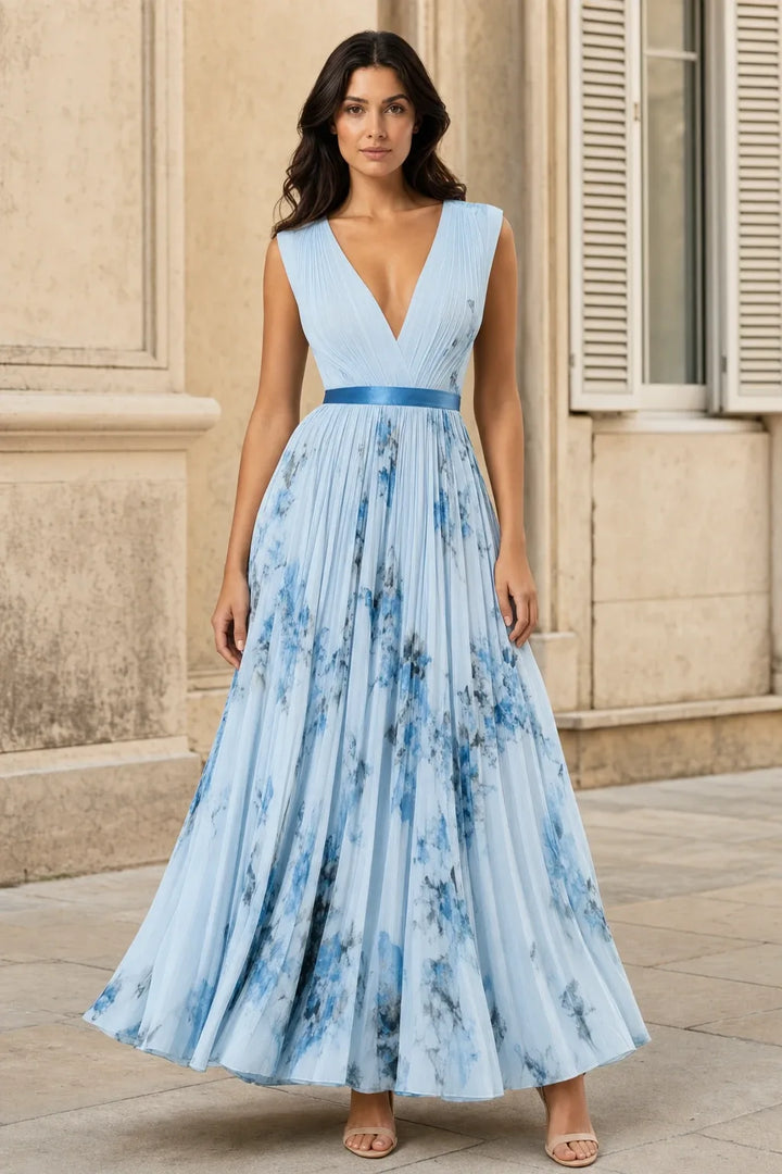 Blue pleated floral midi dress on a model in a contrapposto stance
