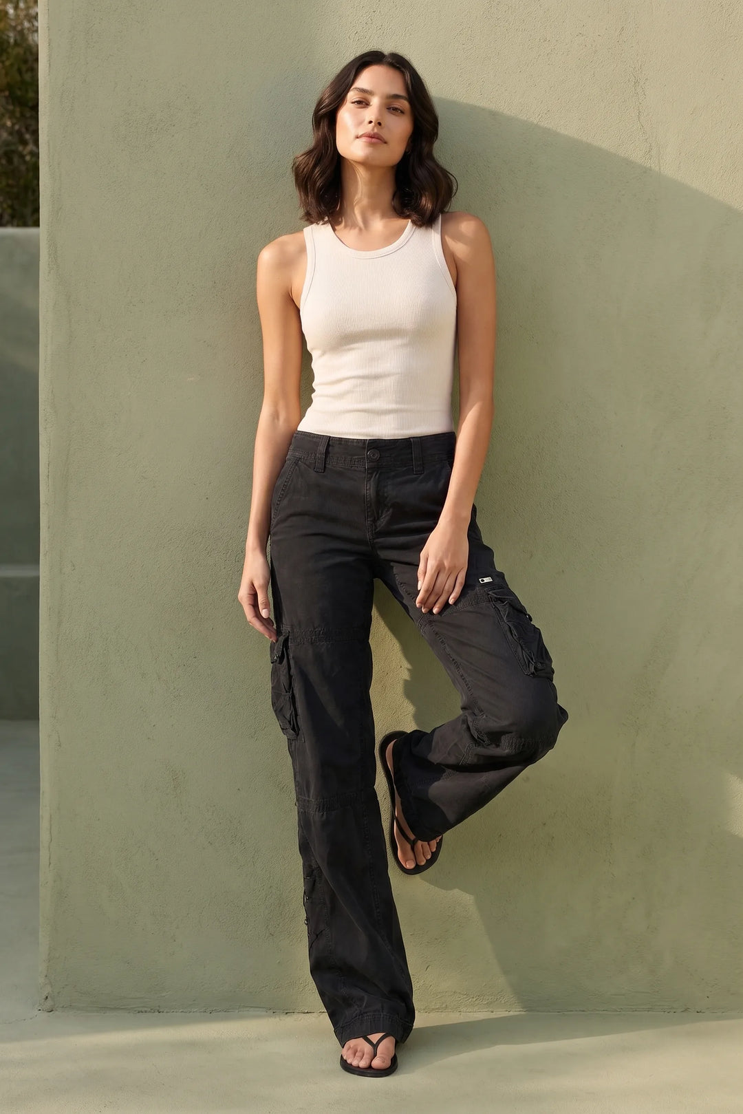 Model wearing black wide-leg cargo pants in a lifestyle setting